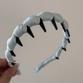 Detail of light blue satin fabric headband with inner non-slip shark teeth hair combs - Blue