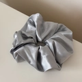 Detailed view of silver satin scrunchie with shimmering glitter and smooth metallic luster - Shimmer Scrunchie / Blue
