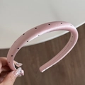Detailed shot of a pink padded headband with black polka dots on high-quality satin - Narrow Headband / Pink