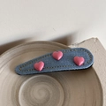 Detail von blauem Denim-Haarclip mit drei rosa Herz-Anhängern auf Keramikschale - Rosa Langer Wassertropfen Stil (Herz Denim-Pink Lang Wassertropfen)