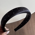 Detailed macro view of the thick black satin headband with classic white polka dots - Wide Headband / Black