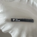 Detailed close-up of a plaid hair clip with a heart rhinestone and lar mood text - Black Plaid
