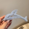 Close-up of light blue dolphin hair claw clip with glitter finish for elegant hair styling - Dolphin / Blue