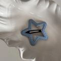 Detail of star-shaped blue denim hair clip with decorative stitching on white plate - Light Blue Denim-Star