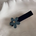 Detailed close-up of dark blue floral hair clip with pearl center on shell tray - Flower Clip Blue