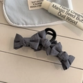 Detail of grey bow hair claw clip with linen texture on a stylish lifestyle background - Grey Bow Claw - Large