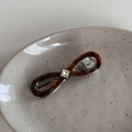 Detail view of acetate infinity hair clip with tortoiseshell texture and crystal - Blue Coffee