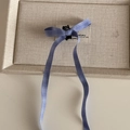 Detail of blue plaid bow hair clip with long ribbons and small black claw attachment - Blue Plaid