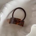 Detail of tortoiseshell acetate hair tie with France Handmade text in a shell bowl - Blue Coffee