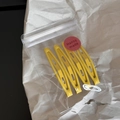 Detailed view of 4 yellow matte snap hair clips in transparent poly bag packaging - Yellow