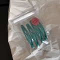 Set of four dark green metal snap hair clips neatly packed in a clear zipper bag - Dark Green