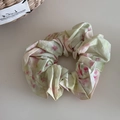 Detailed shot of green floral scrunchie with pink oil painting pattern and soft pleats - Iridescent Floral Green