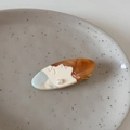 Macro detail of oval acetate hair clip featuring an abstract female face and pearl - Amber Brown