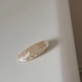 Macro detail of oval acetate hair clip in pearl white with gold handmade lettering - Mermaid White