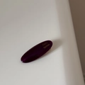 Close-up of a purple oval acetate hair clip with France Handmade gold lettering detail - Fuschia