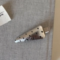 Close-up of a silver carrot-shaped hair clip with black polka dots on a grey fabric base - Silver Triangle Polka Dot Leather