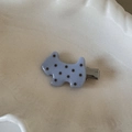 Détail d'une pince à cheveux petit chien lilas à pois marrons sur une assiette blanche - Pince Chien / Bleu