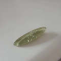 Detail of oval resin hair clip with embedded shimmering shell fragments on white background - Green