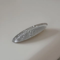 Detail of oval hair clip featuring grey translucent resin and silver glitter sparkles - Gray