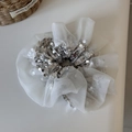 Detail of white organza scrunchie with silver sequins and ruffled mesh fabric texture - Beige