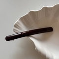 Macro detail of dark brown acetic hair clip with golden Barrette La France text - Dark Coffee