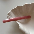 Close-up of pink marble pattern acetate hair clip on a white shell decorative tray - Pink