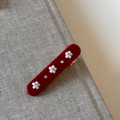 Dettaglio del fermaglio rosso rettangolare con piccoli fiori bianchi e brillantini - Rosso