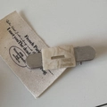Detail view of acetate hair clip with silver metal base and France Handmade engraving - Off-white