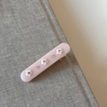 Dettaglio molletta rosa con piccoli fiori bianchi e strass su base in metallo dorato - Rosa
