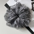 Detail of grey organza scrunchie with black polka dots and elegant double-layer fabric - Gray