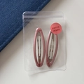 Detail of two glitter pink oval BB hair clips inside a clear plastic bag on white background - Oval Hollow BB - Pink (6.6cm)