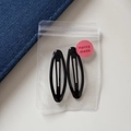 Pair of sleek black oval metal BB hair clips in transparent packaging with pink label - Oval Hollow BB - Black (6cm)