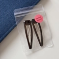 Detailed view of two leopard print hair clips neatly packed in a clear zip bag with a pink label - Triangle Hollow BB - Translucent Brown (6.6cm)