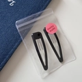 Close-up of black metal triangle hair clips in clear packaging with a pink label - Triangle Hollow BB - Black (6.6cm)