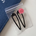 Close-up of two black glossy teardrop BB hair clips in a frosted zipper pouch - Water Drop Hollow BB - Black (7cm)