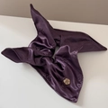 Detail of dark purple satin scrunchie featuring rose jacquard and golden rose metal charm - Purple Rose Jacquard