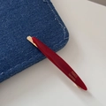 Close-up of red resin hair clip with gold metal base and FRANCE Handmade text - Solid Red