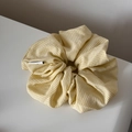 Detalle de coletero de algodón a cuadros amarillos y blancos con textura fina y etiqueta - Coletero / Amarillo