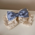 Close-up of elegant double-layered hair clip with blue satin and floral cream lace bows - Blue