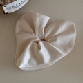 Detailed texture of a soft beige satin scrunchie with elegant silk folds and smooth luster - Off White