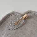Detail showing silver glitter acetate oval clip with a polished gold metal hair grip - Silver