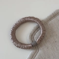 Detail of champagne gold silk-like seamless hair scrunchie with matte gray cylinder buckle - Khaki
