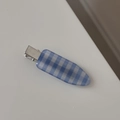 Detail view of a vintage blue and white checkered claw clip with a sleek metal clasp - Blue and White Checkered Duckbill Clip