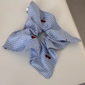 Detail shot of a blue and white checkered cotton scrunchie with red cherry embroidery art - Blue Plaid Red Cherry Square Scrunchie