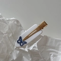 Detailed close-up of marble pattern hair clip with blue rhinestone butterfly design - White Butterfly