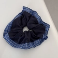 Detail of blue and white checkered scrunchie with layered fabric texture for ponytails - Blue Series - Checkered Navy