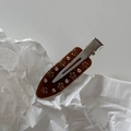 Close-up of amber acetate hair clip with delicate rhinestone flower and silver duckbill clamp - Coffee Flower