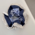Detail of blue satin and striped hair scrunchie with cream lace trim on white surface - Blue Series - Dotted Navy