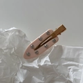 Detailed macro view of pink marble acetate hair clip with sparkling inlaid crystals - Creamy Apricot Rhinestone