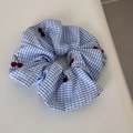 Detail of blue gingham scrunchie with red cherry embroidery and elastic texture - Blue Plaid Red Cherry Scrunchie
